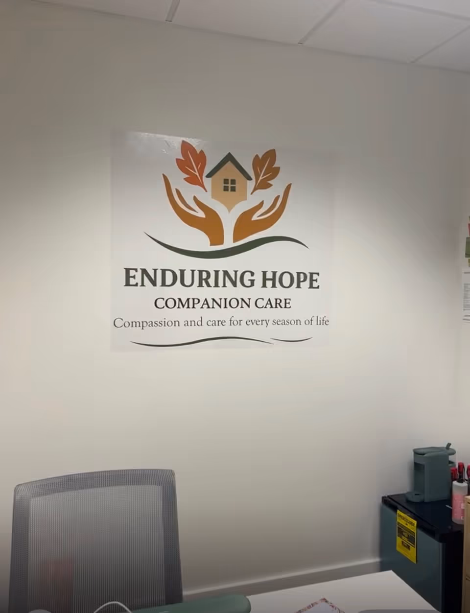 Interior office space with Enduring Hope Companion Care sign on the wall.