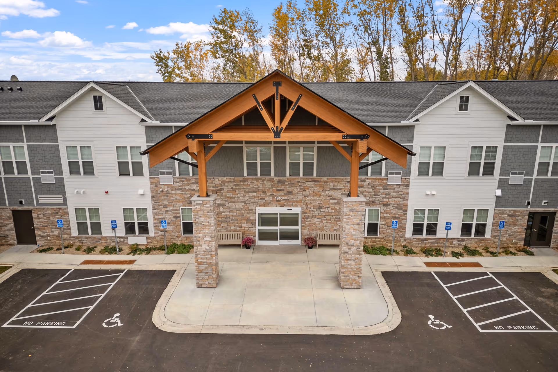 Caretta Senior Living Maplewood exterior with covered entrance, stone pillars, and accessible parking.