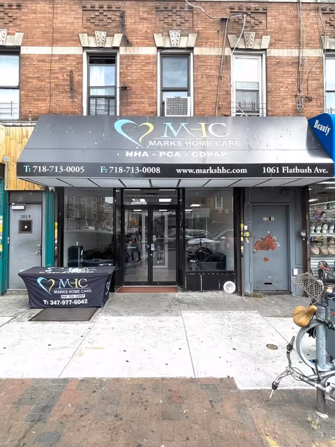 Exterior of Marks Home Care Agency storefront with sign, glass doors, and awning.