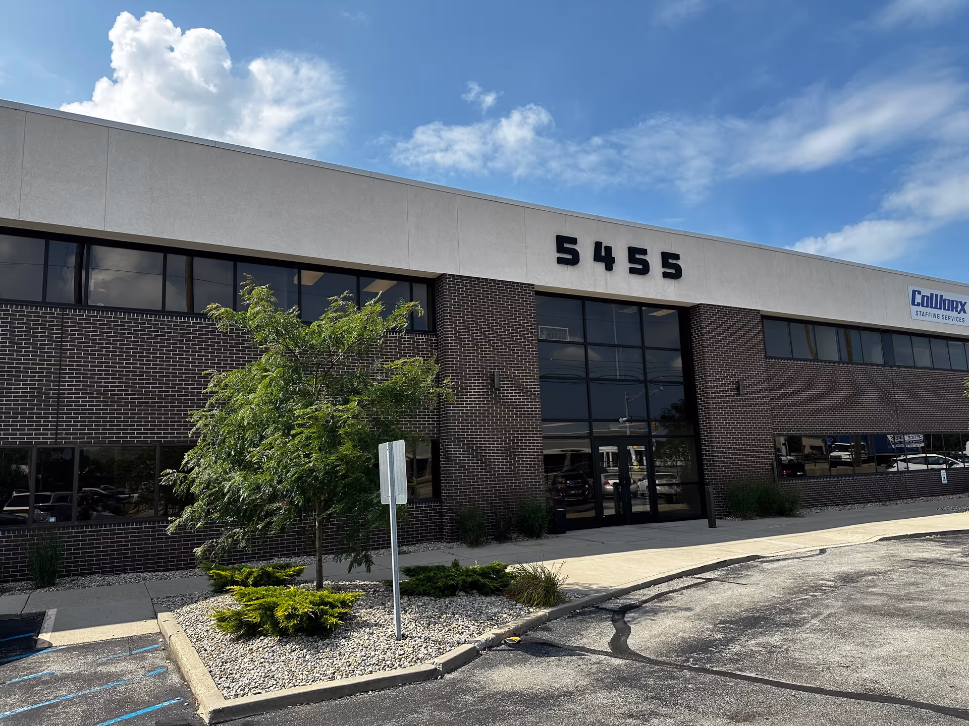 Exterior view of Haven Of Care building with brick facade, glass entrance, and landscaping.