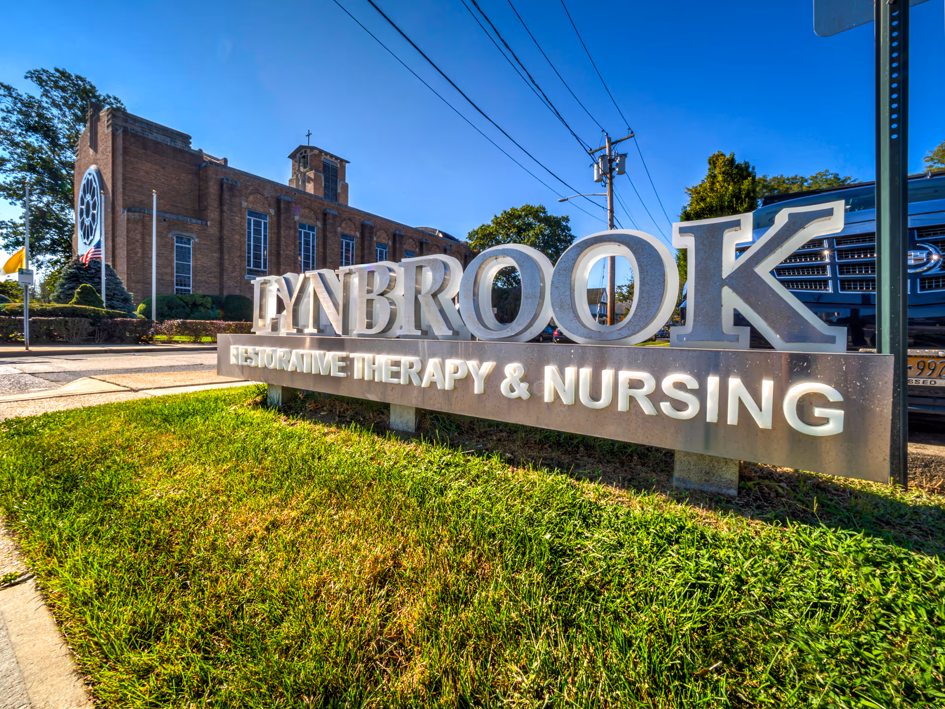 Exterior view of Lynbrook Restorative Therapy and Nursing with large entrance sign.