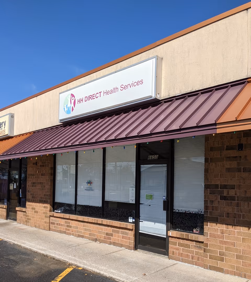 Exterior view of HH Direct Health Services storefront with a maroon metal awning.