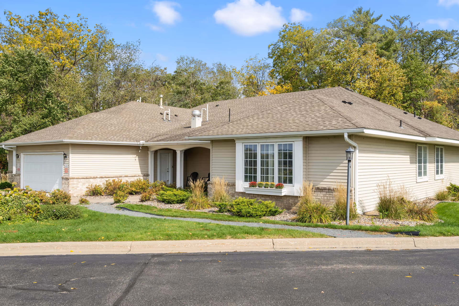 Front exterior of Augustana Emerald Crest III single-story building with landscaped entry and driveway