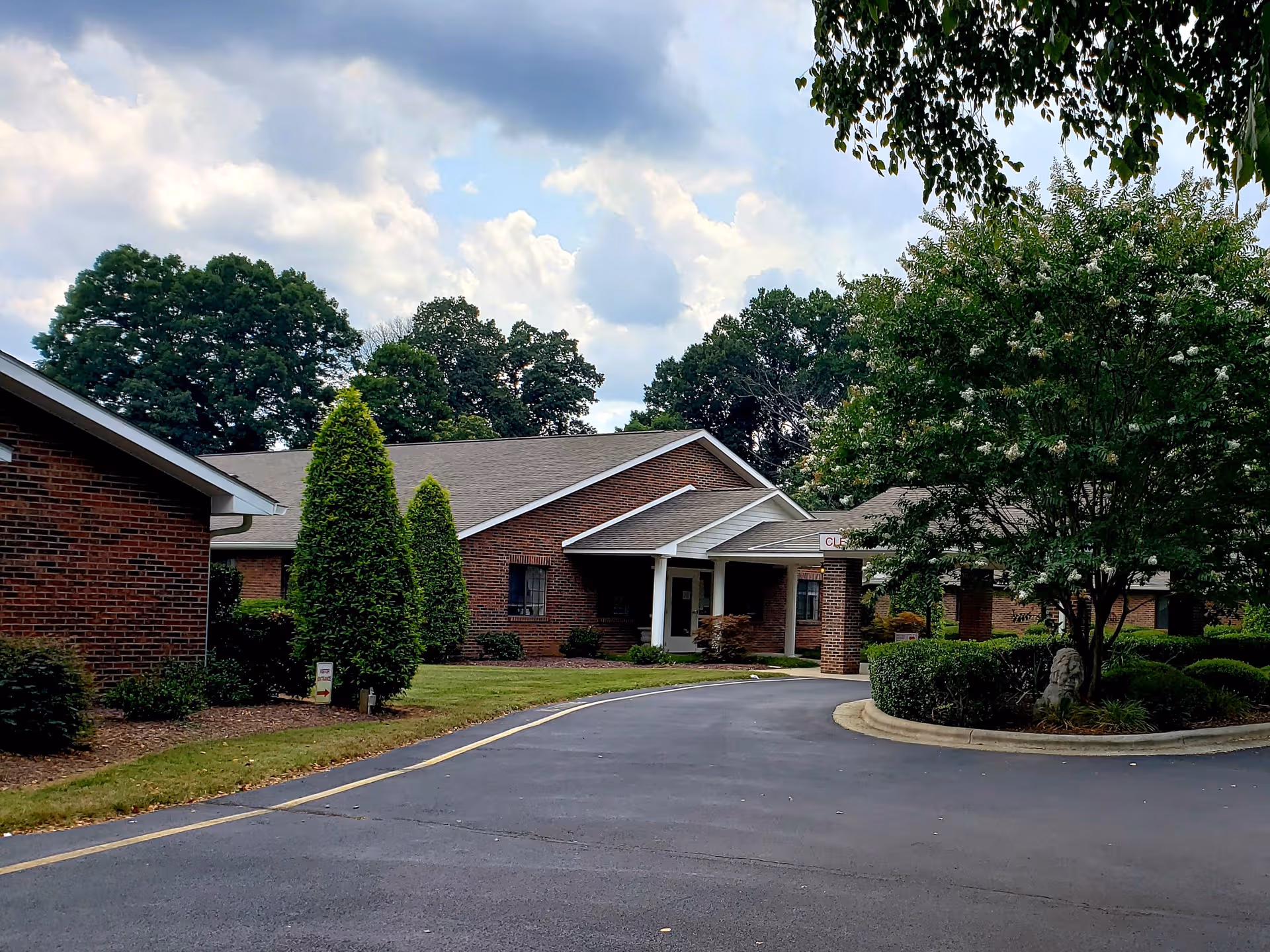 Front view of a brick Peak Resources Brookshire senior living facility entrance.