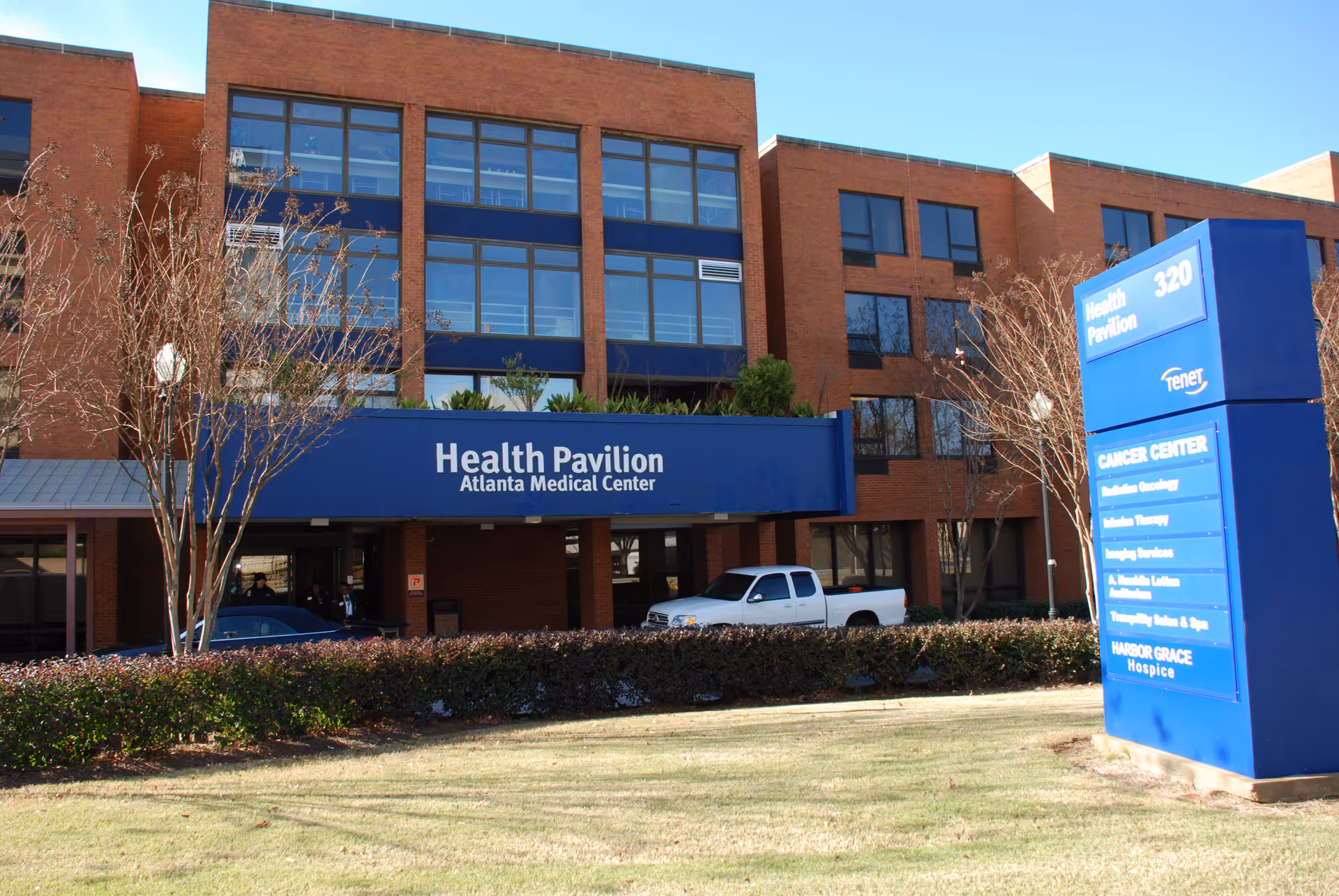 Brick medical building with blue Health Pavilion sign and directory board.