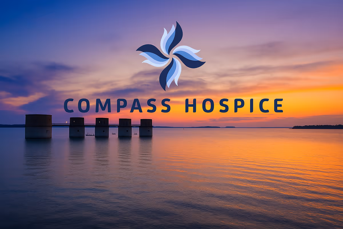 Sunset over calm water with Compass Hospice logo and five cylindrical structures.