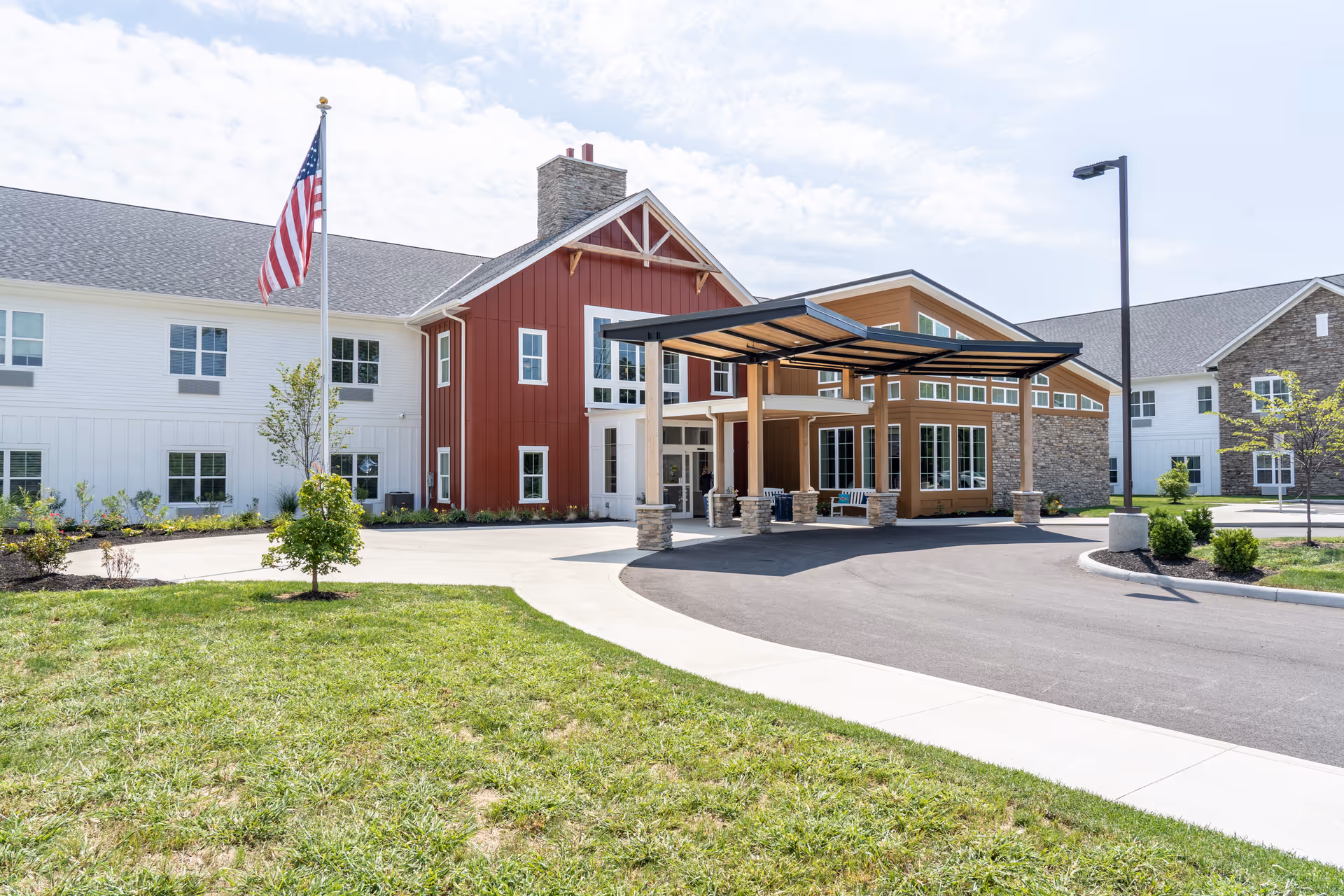 Exterior view of Canal Winchester Care Center with entrance canopy and flag.