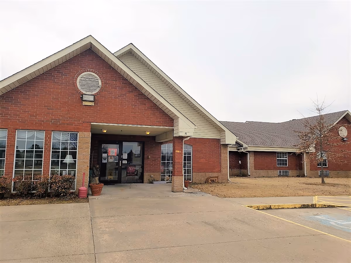 Beare Manor senior living facility exterior with brick facade and glass entrance.