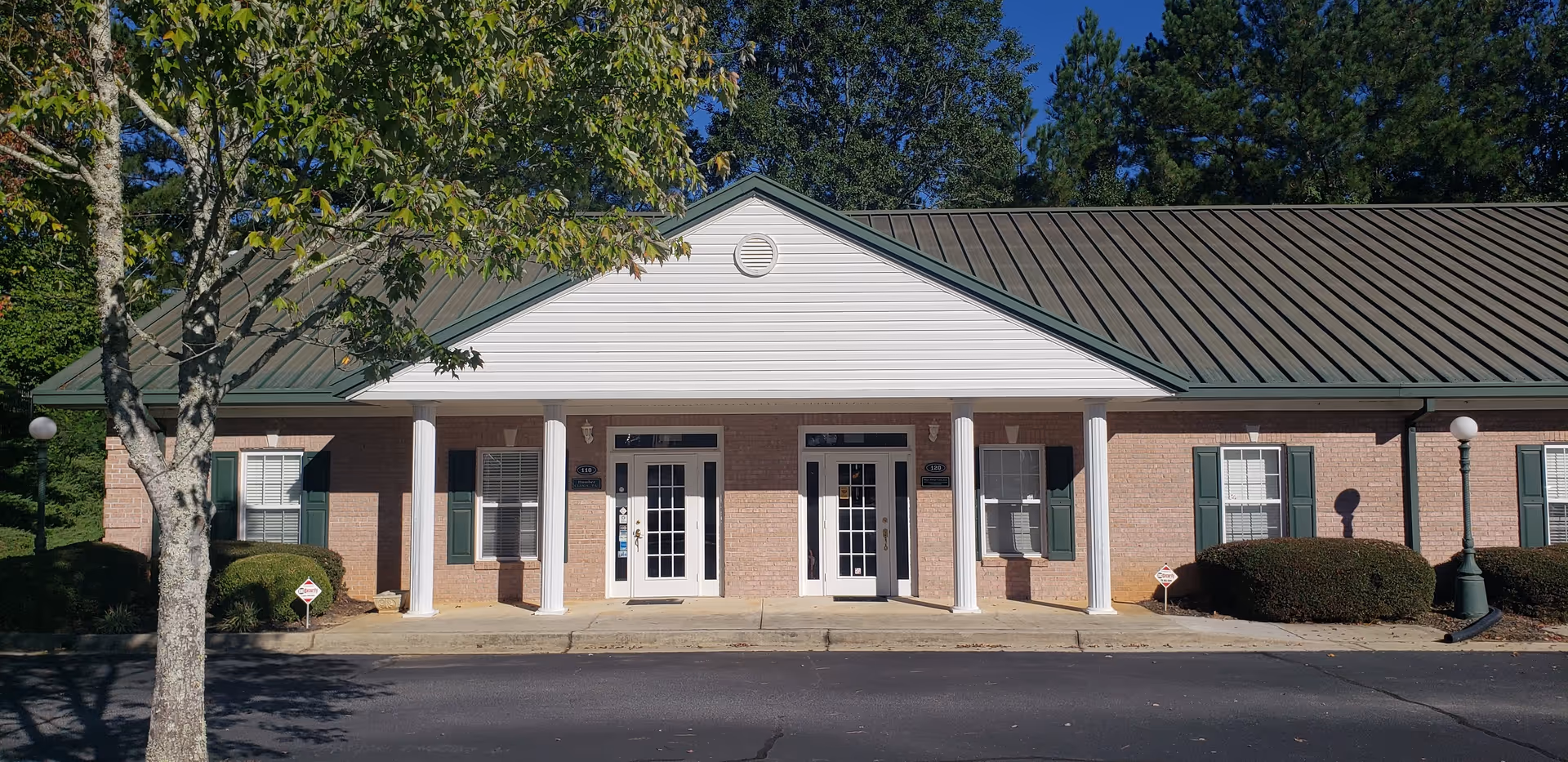 Hope Private In-Home Care facility entrance with brick exterior, white columns, and double doors.