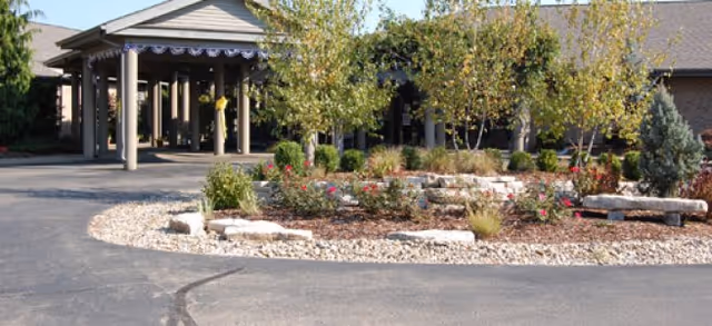 Exterior view of Brookdale Zanesville entrance with landscaped garden and walkway.