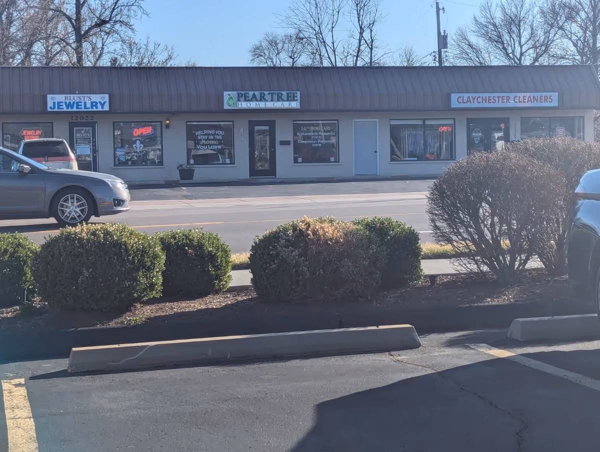 Exterior view of a strip mall with Pear Tree Home Care storefronts.