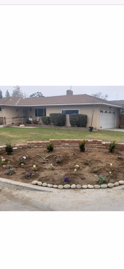 Front view of a single-story senior facility with a landscaped front garden.