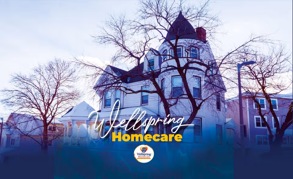 Exterior view of a large Victorian-style home with Wellspring Homecare branding.