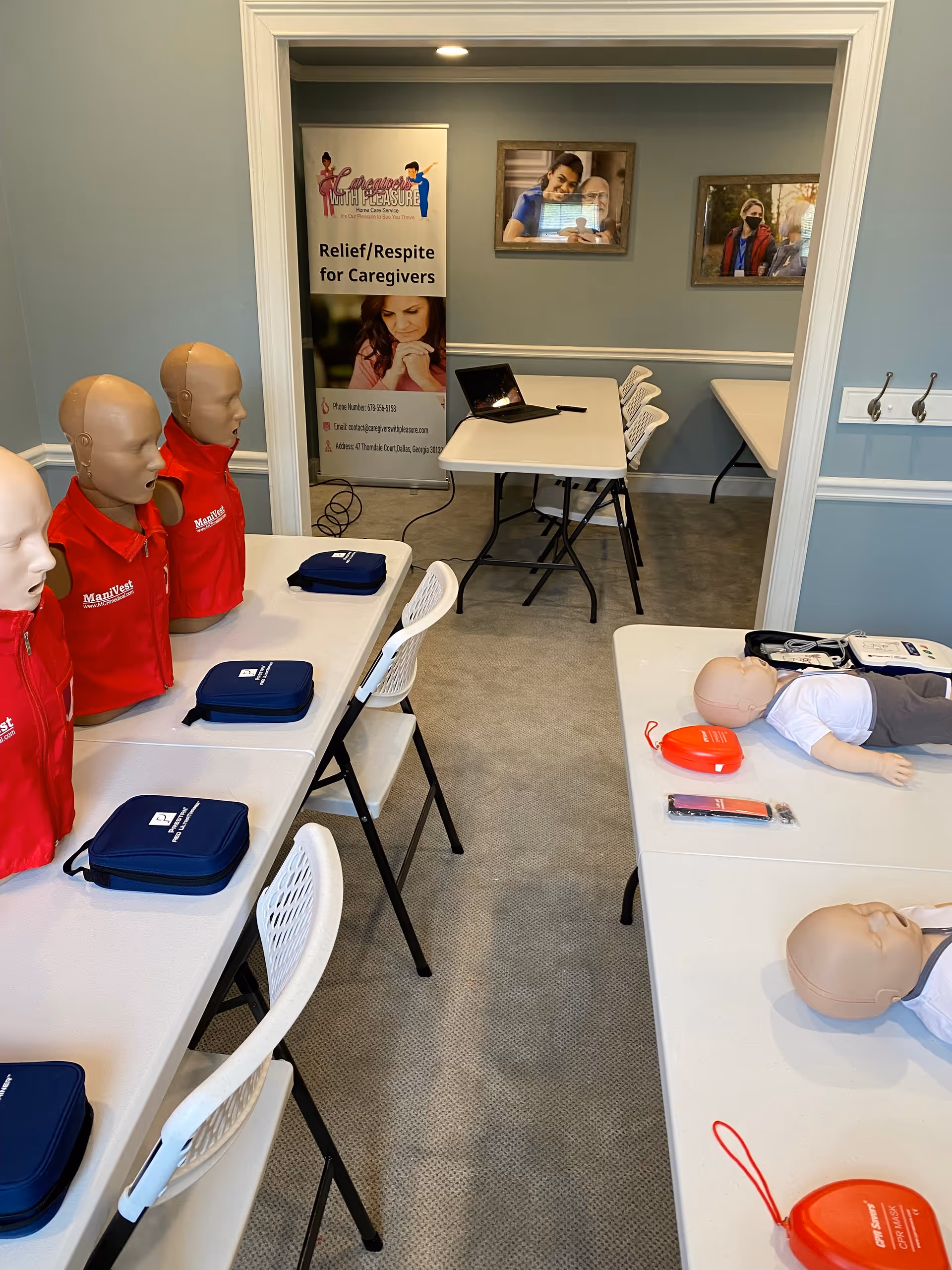 Training room with CPR mannequins and a laptop on a table.