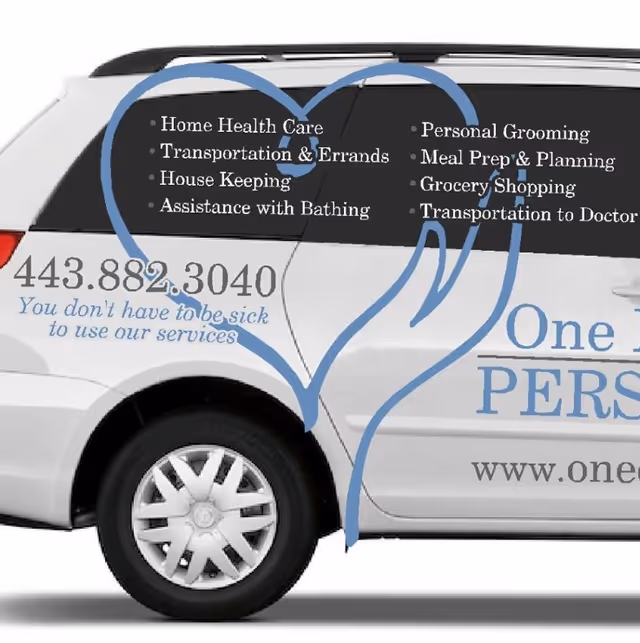 White van with blue promotional text advertising senior care services on its side.
