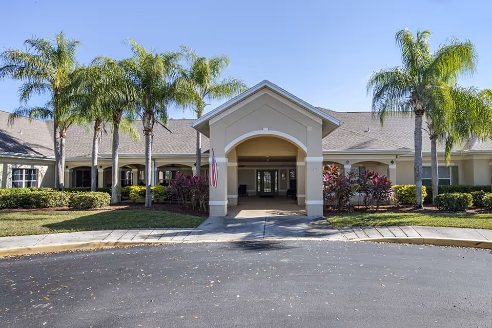 Exterior view of Brookdale Santa Barbara entrance with palm trees and porte-cochère.