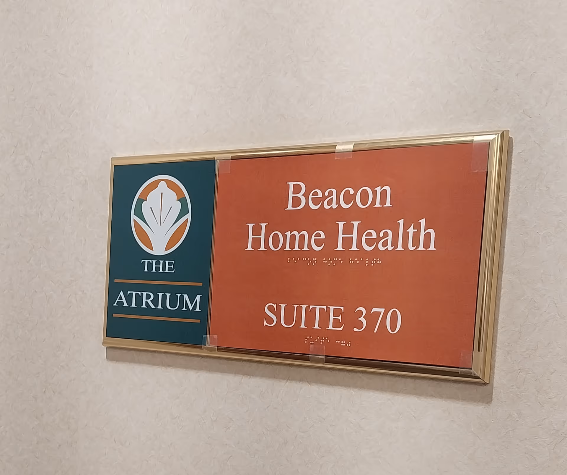 Interior wall sign displaying Beacon Home Health, The Atrium, Suite 370.