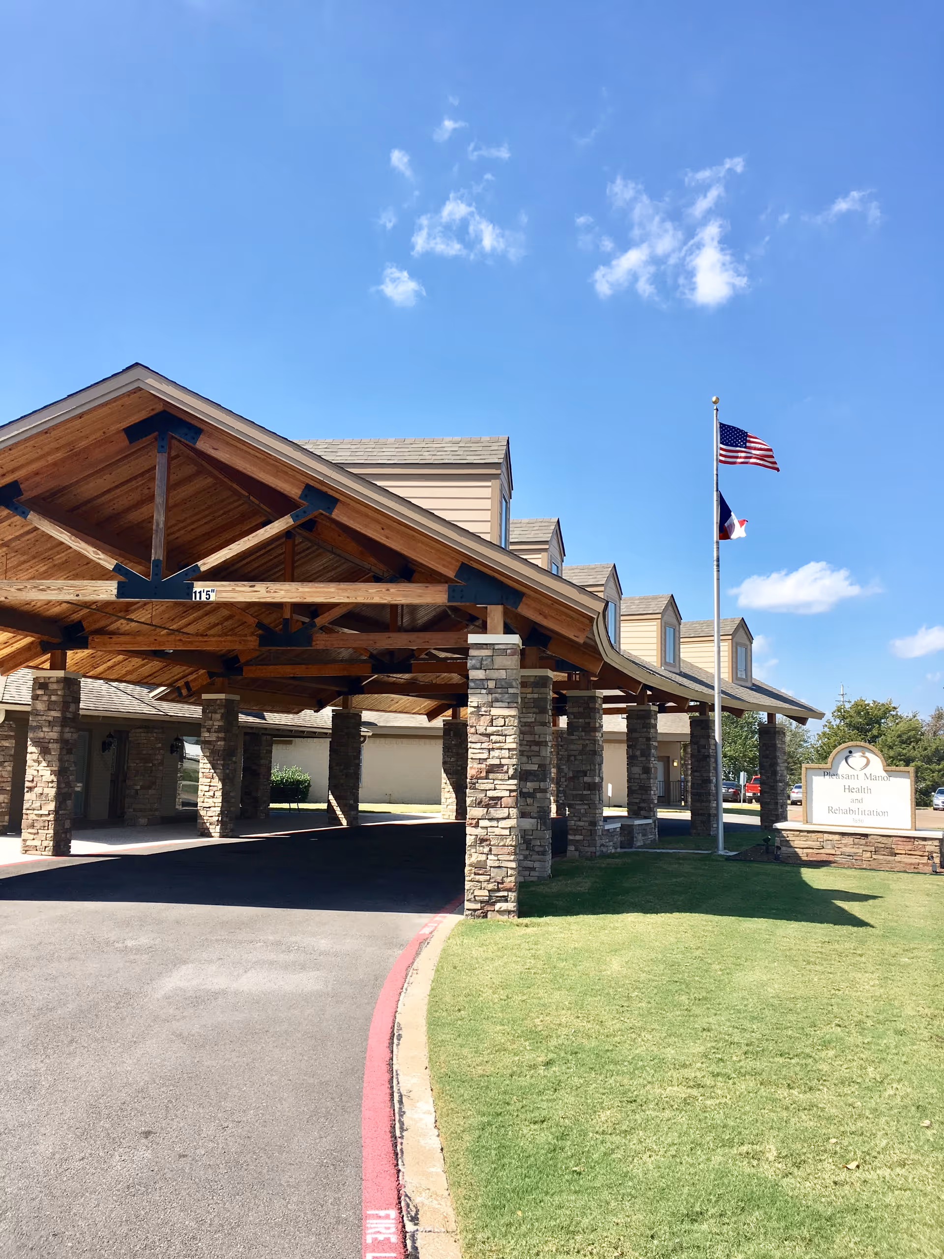 Front entrance of Pleasant Manor Health & Rehabilitation Center with stone columns.
