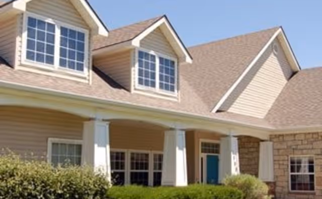 Front exterior of a Brookdale Greeley senior living building with pillars and windows