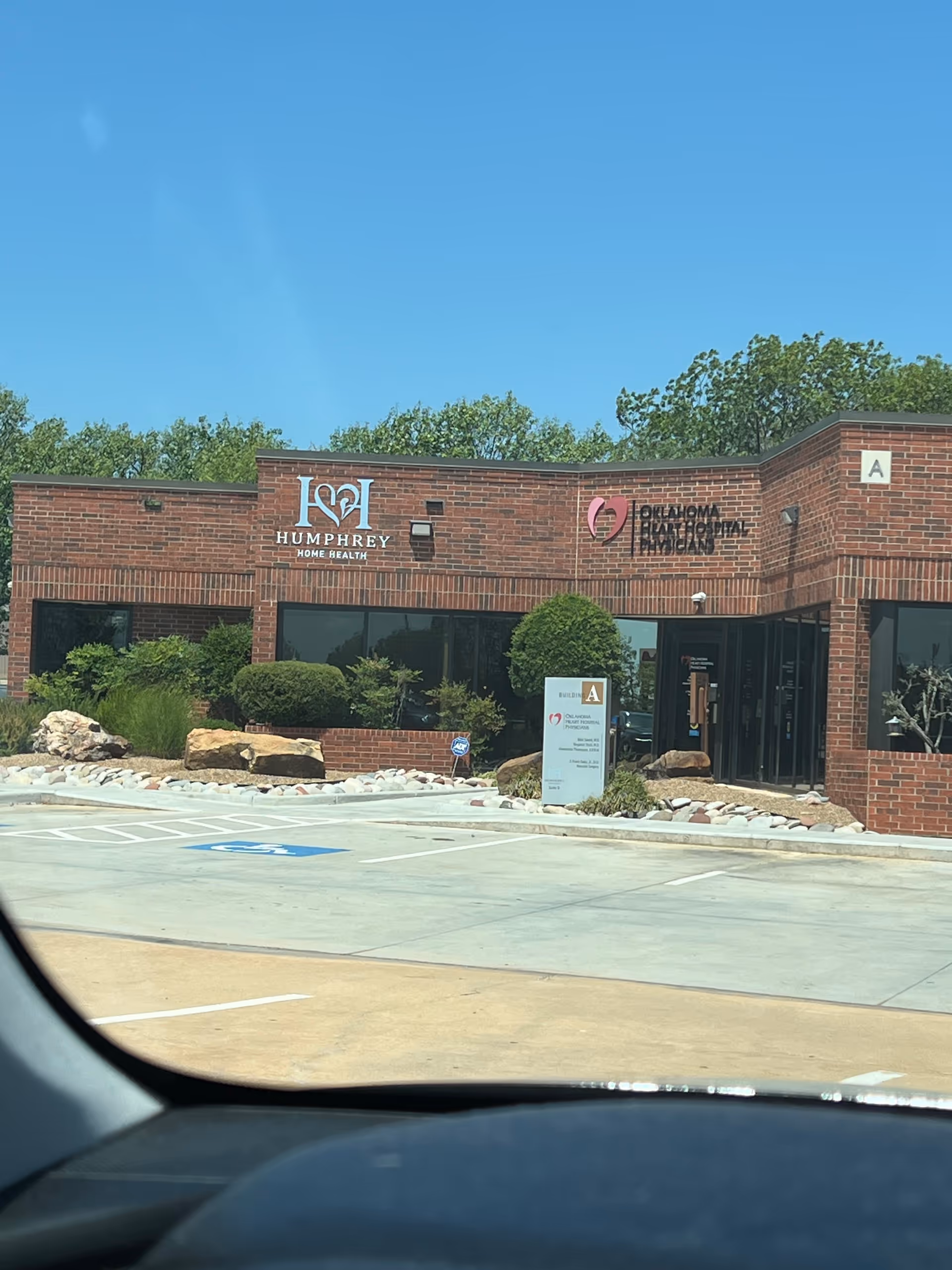 Brick building facade with Humphrey Home Health sign and parking lot in front