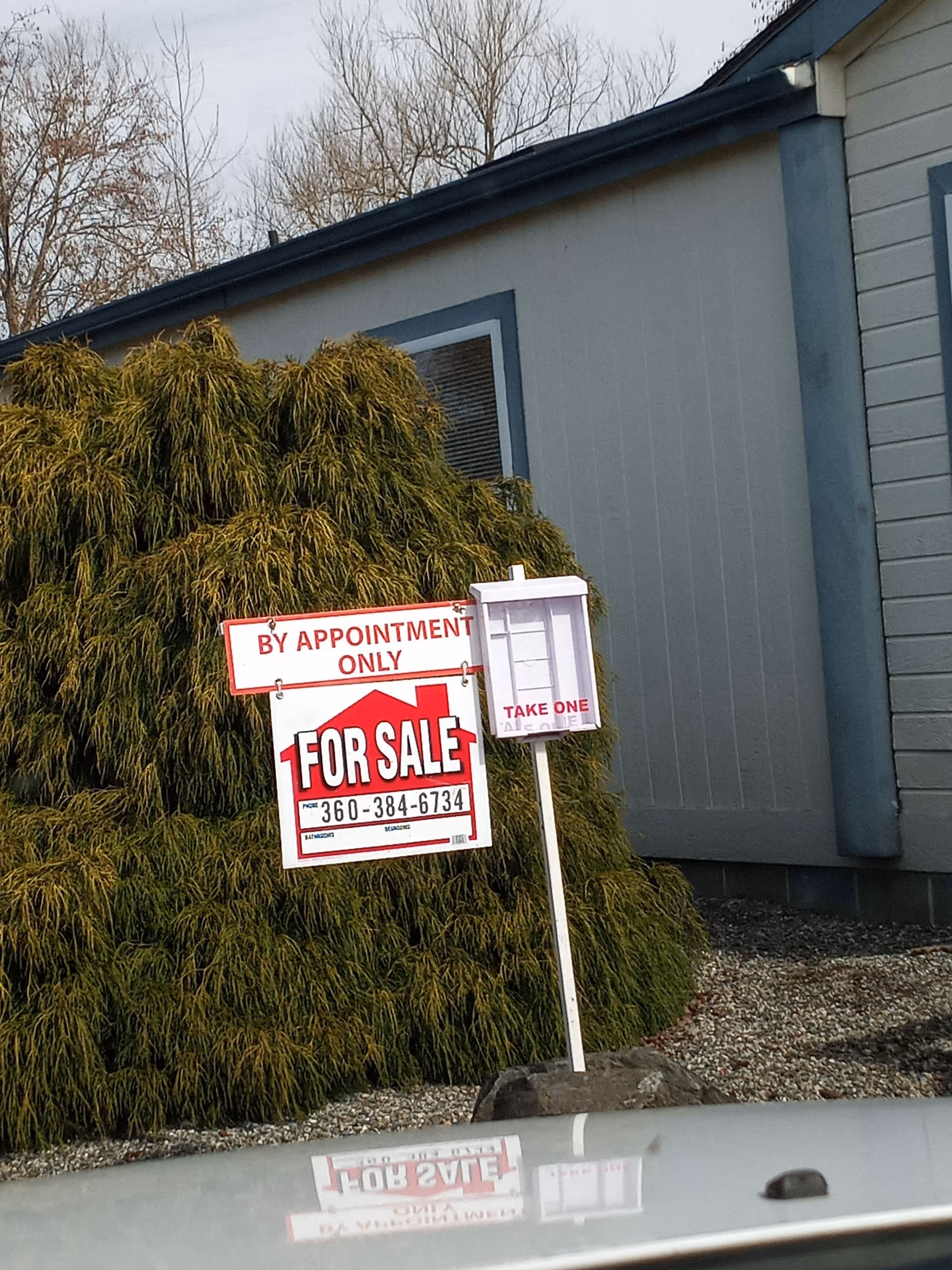 Exterior view of a building with a For Sale sign and By Appointment Only sign.
