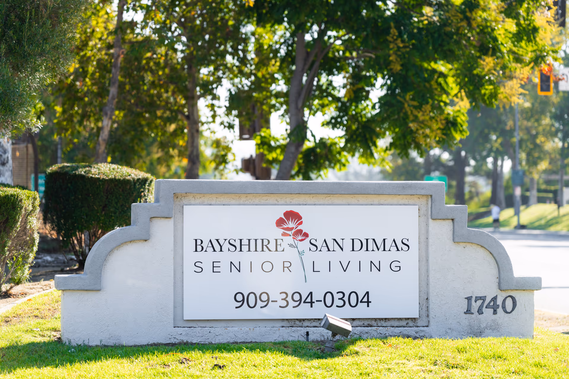 Outdoor stone sign for Bayshire San Dimas Senior Living with phone number 909-394-0304.