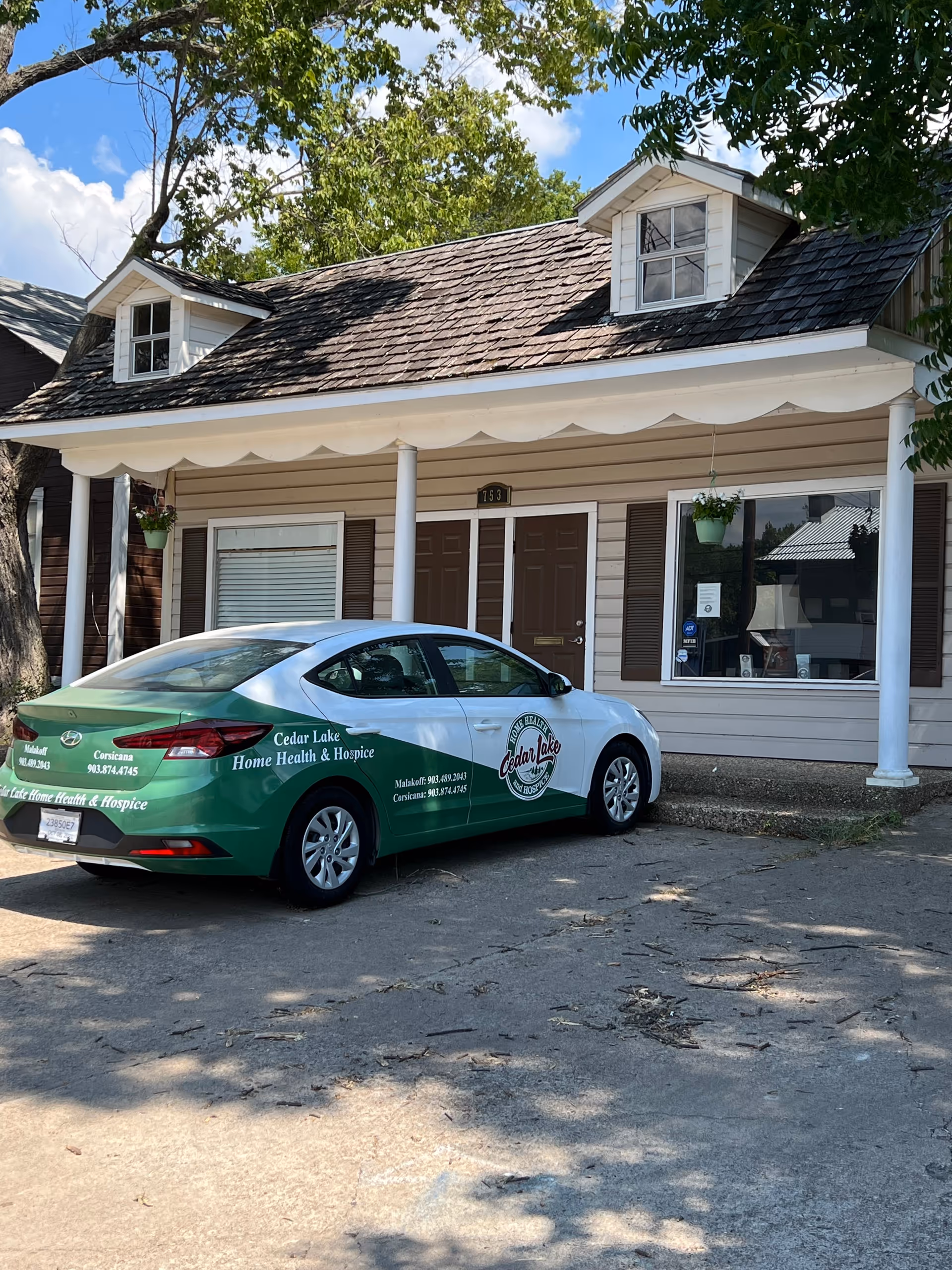 Front view of Cedar Lake Home Health & Hospice building with a green car parked.