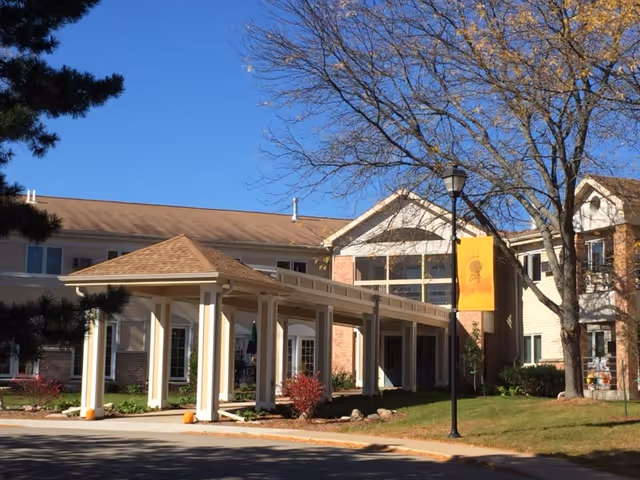 Exterior view of Trinity Pines Retirement Center showing its covered entrance and trees