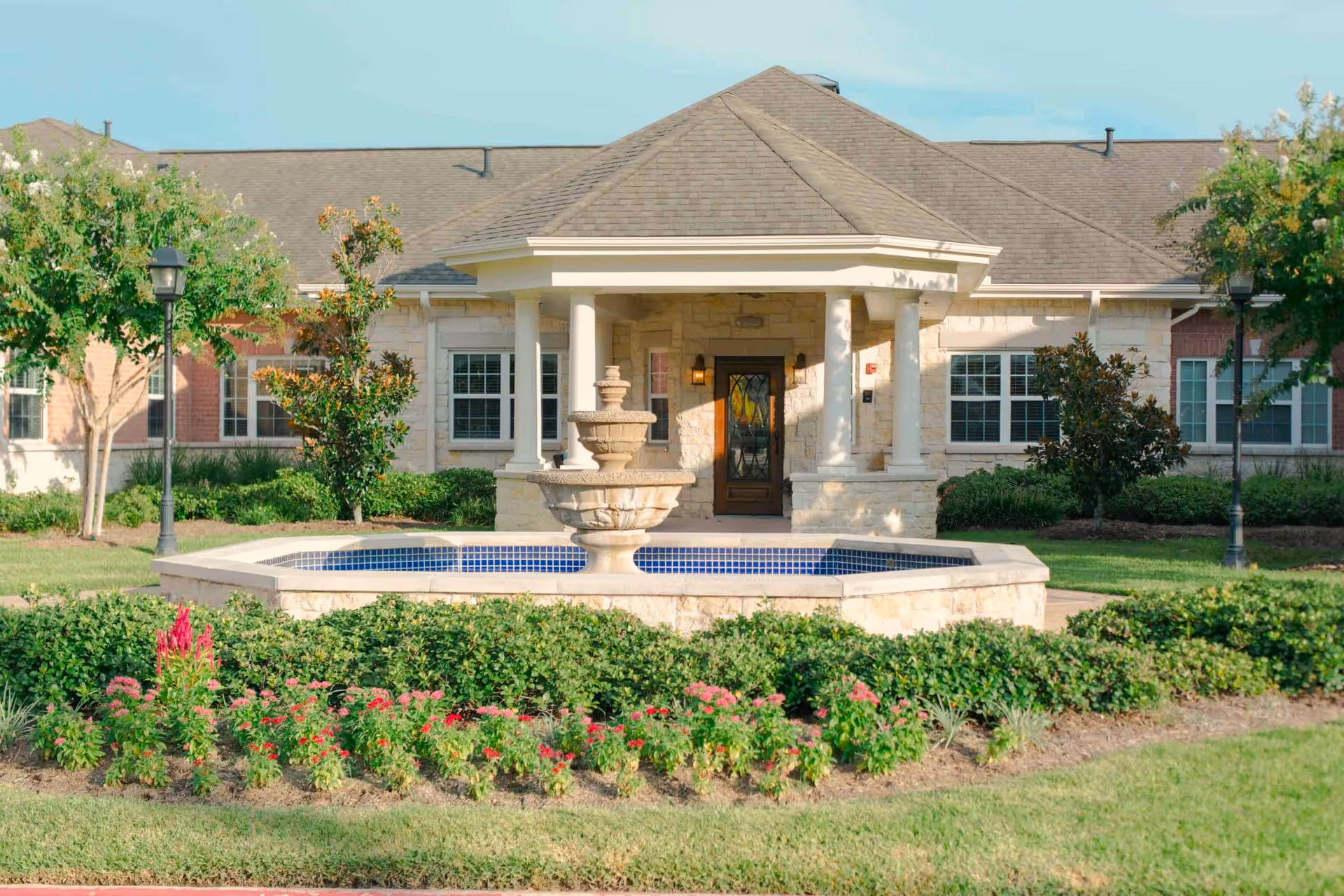 Front entrance of Autumn Leaves of Cypresswood with fountain and landscaped grounds.