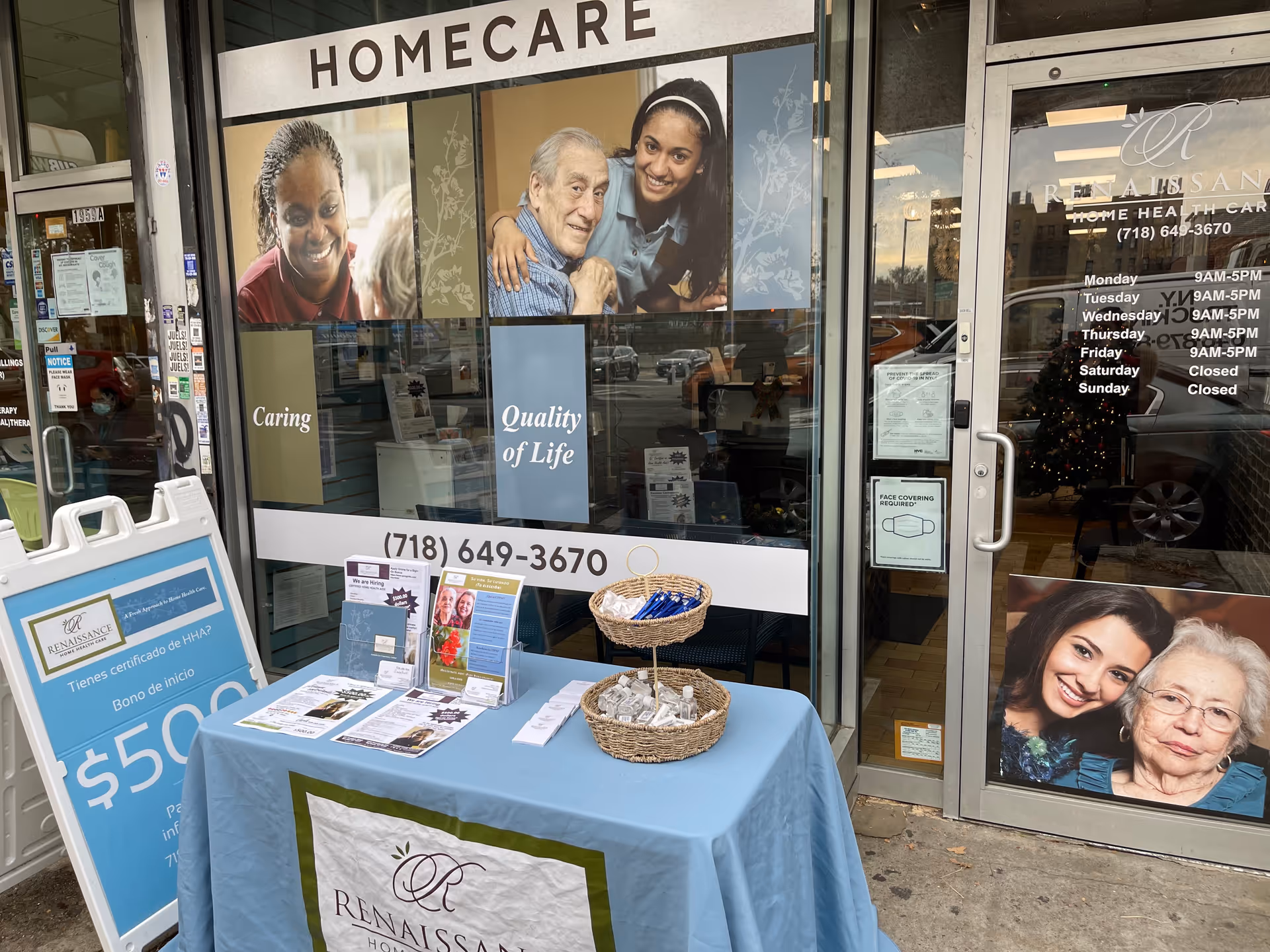 Storefront of Renaissance Home HC with a promotional table and brochures outside.