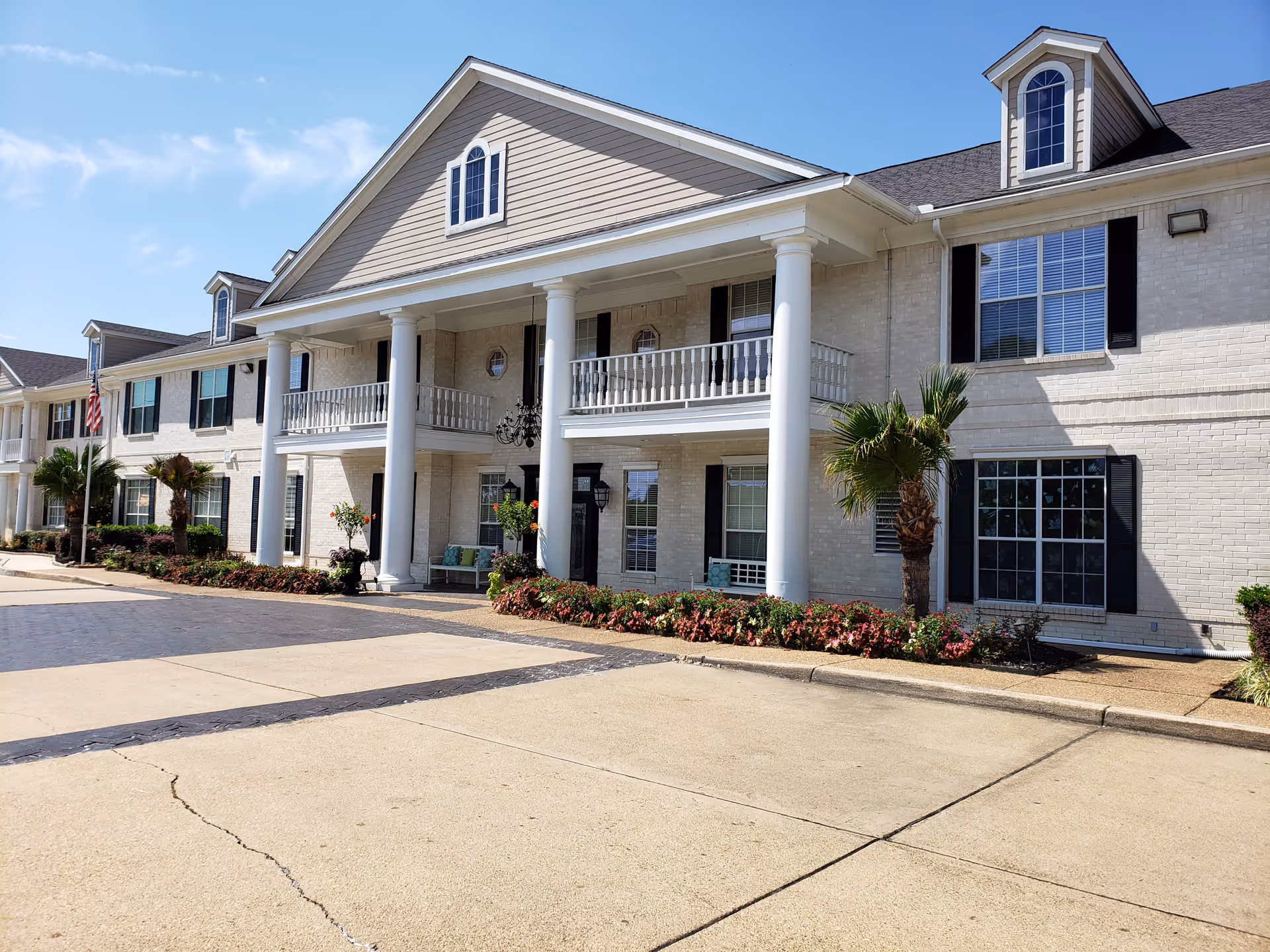 Montclair Park Assisted Living building exterior with columns, balconies, and landscaped front.