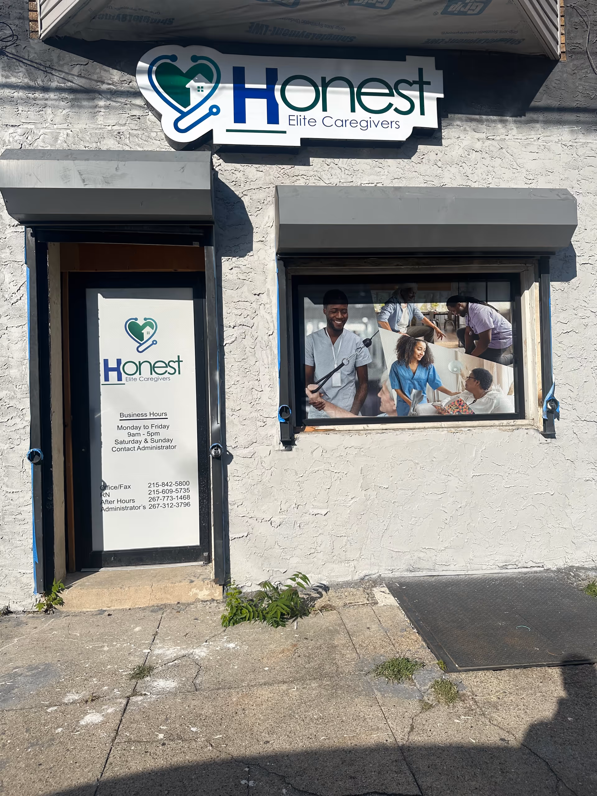 Exterior of Honest Elite Caregivers building with sign, door, and window display.