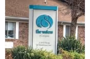 Exterior view of The Waters of Covington sign beside a brick facility entrance.