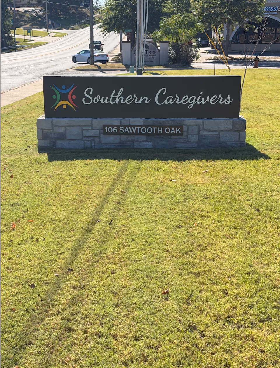 Exterior sign for Southern Caregivers on a grassy lawn by the street.