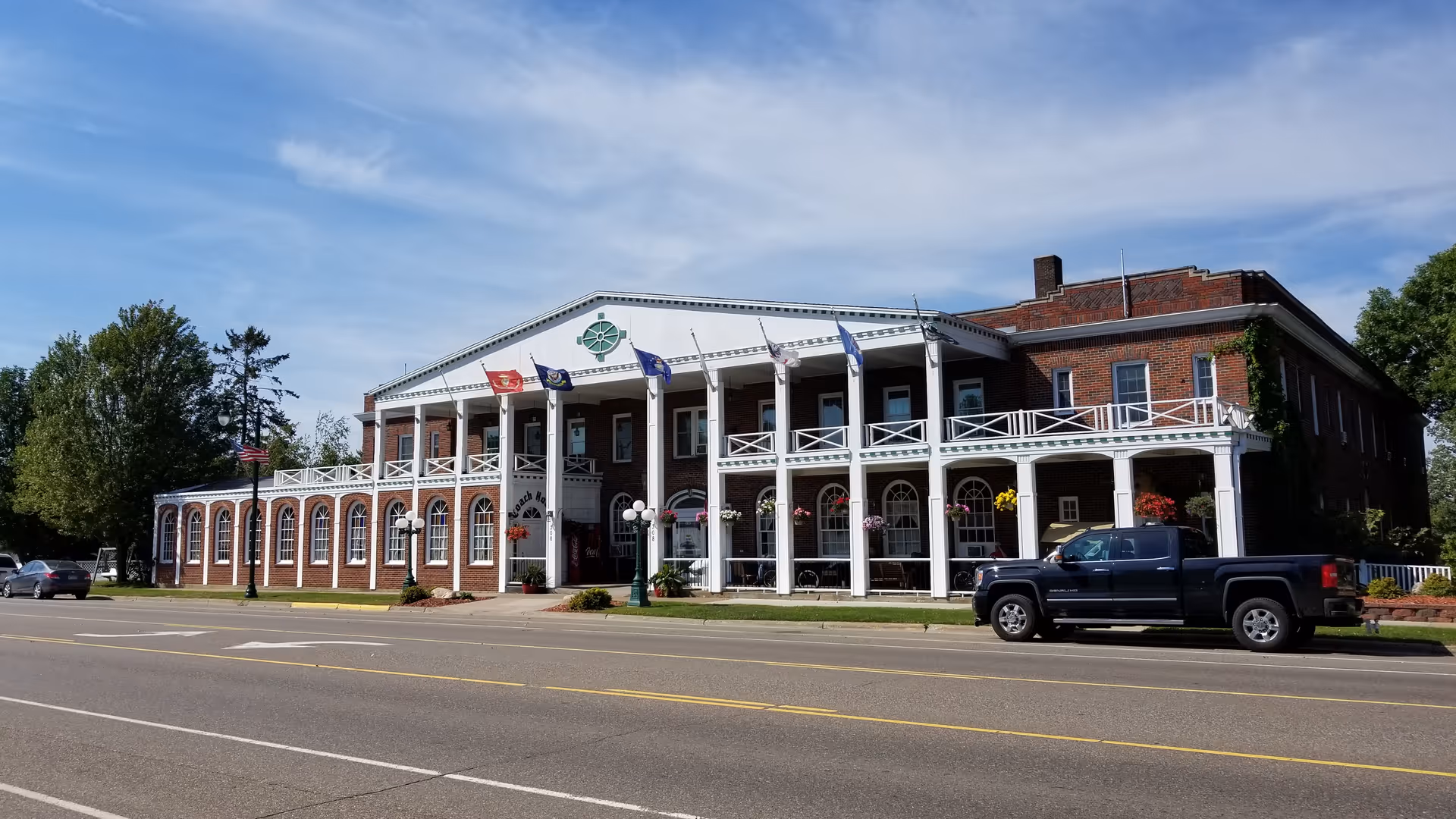 Front view of a brick senior living facility with a white porch.