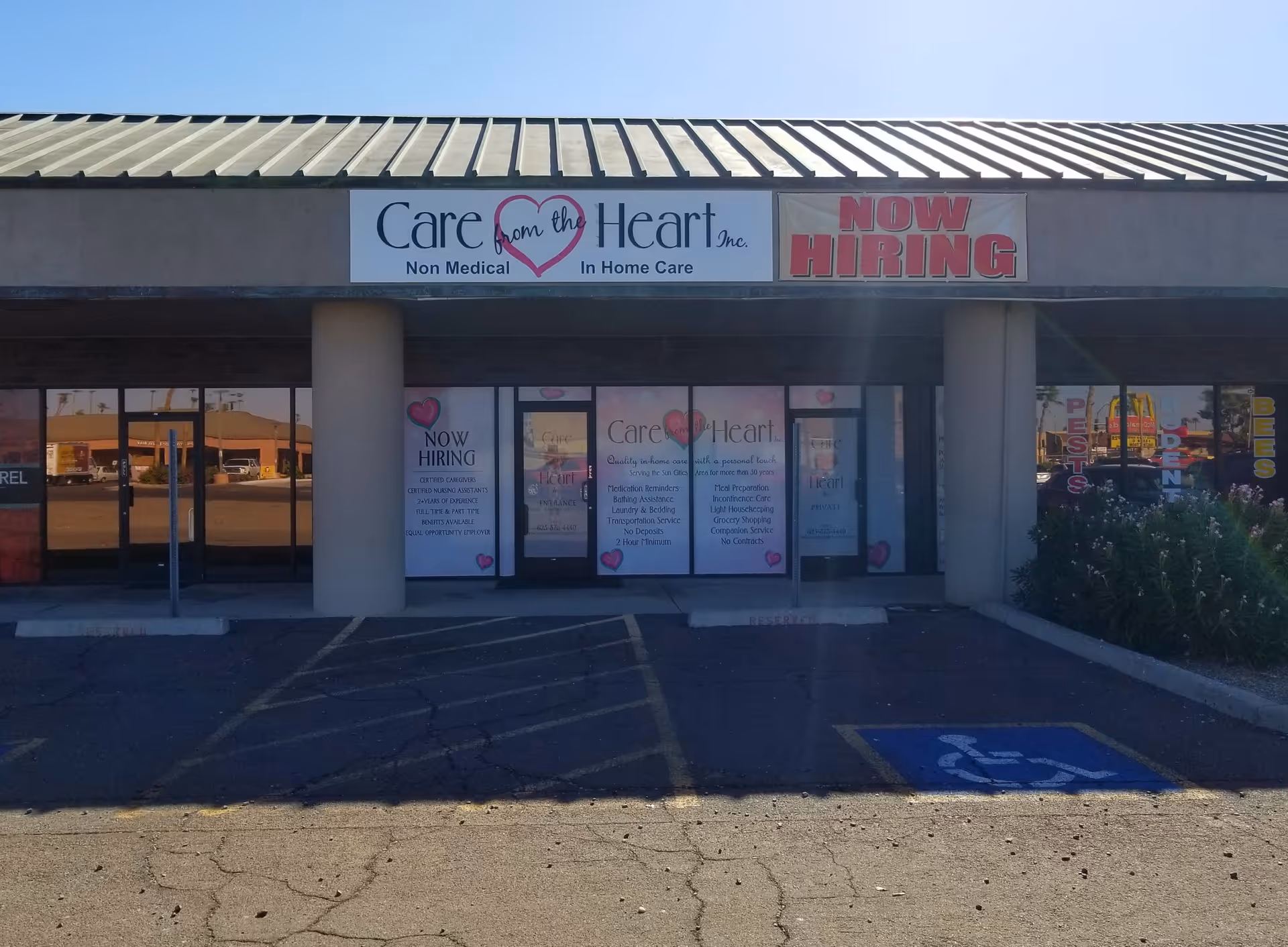 Storefront of Care from the Heart, Inc. with 'NOW HIRING' signs.