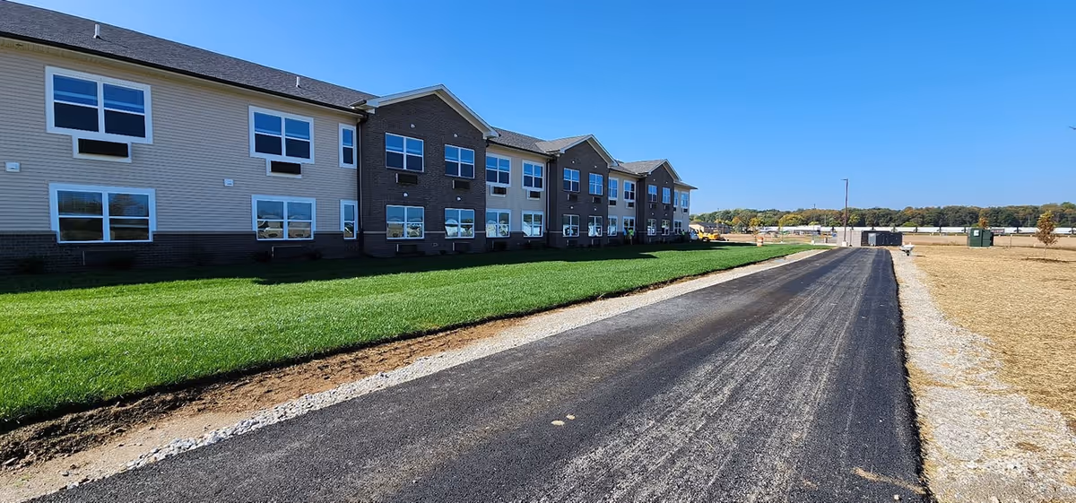 Exterior of Autumn Trace Connersville Assisted Living building along a paved road.