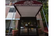 Entrance canopy with sign reading Park Gardens Rehabilitation & Nursing Center above the doorway.