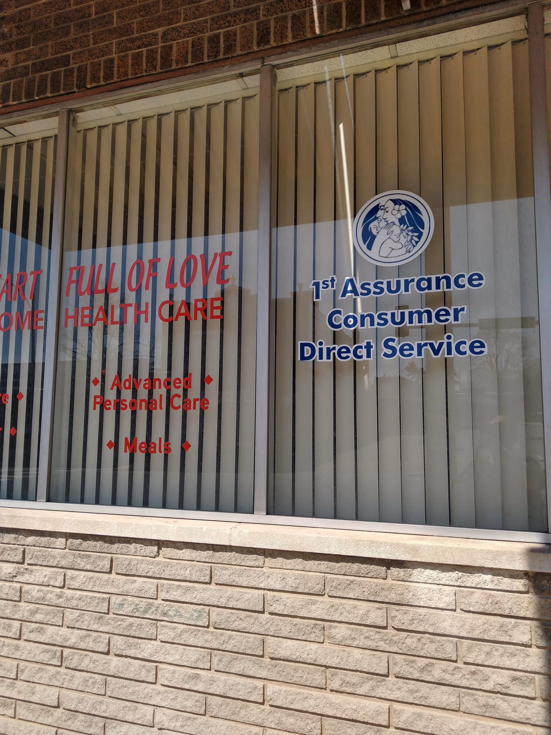 Storefront window displays red and blue signage for A Heart Full of Love facility.