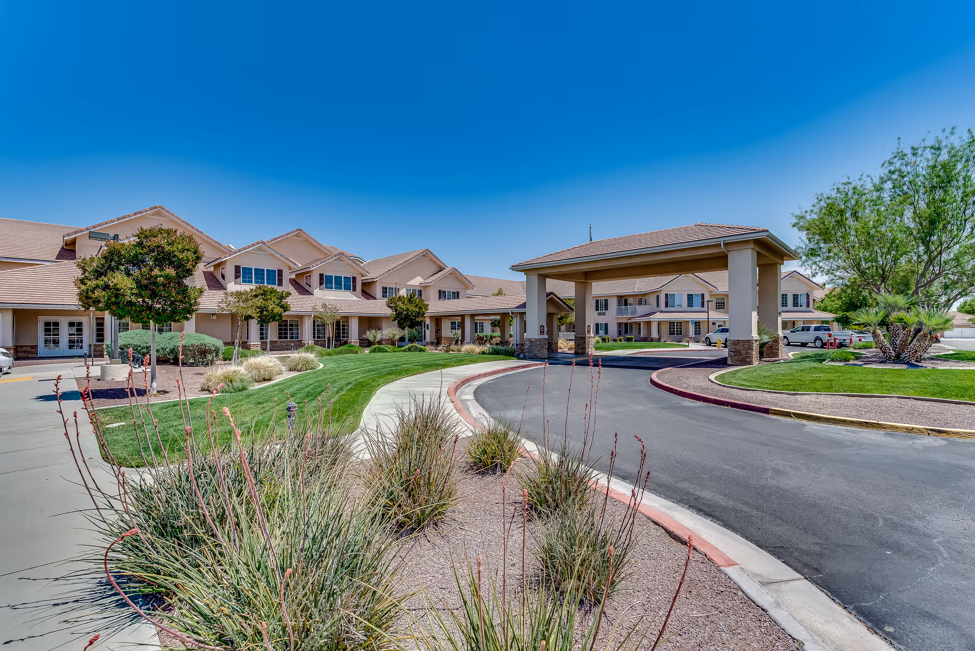 Exterior view of Solstice Senior Living at Apple Valley with a curved driveway and entrance.