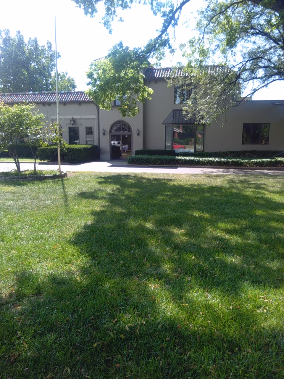 Exterior view of Accessible Home Care, LLC building with green lawn and front entrance.