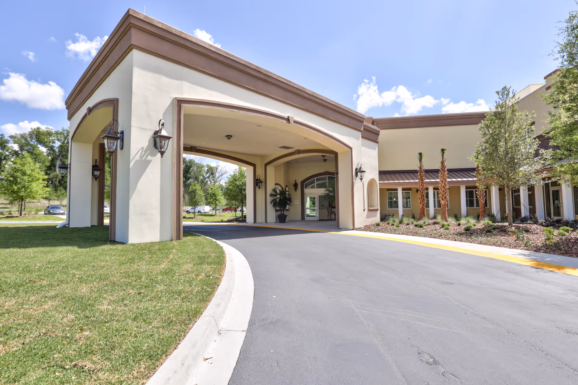 Exterior view of Dolphin Pointe Health Care entrance with curved driveway and landscaping.