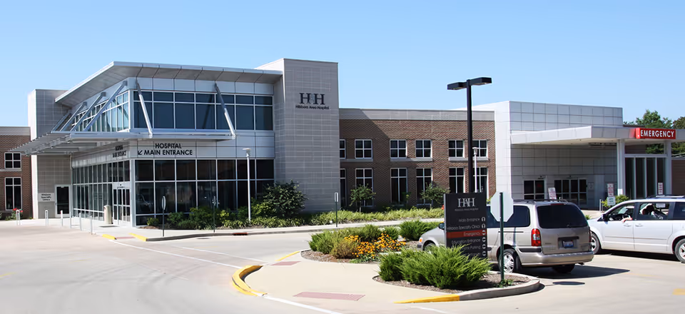 A Hillsboro Health exterior view showing the main entrance and parked cars.