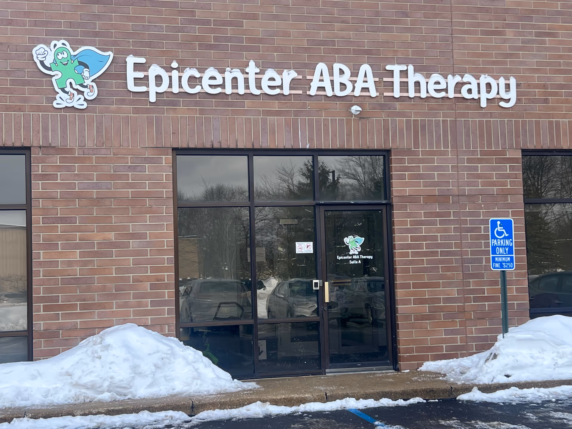Front of Epicenter ABA Therapy building with brick facade and glass doors.