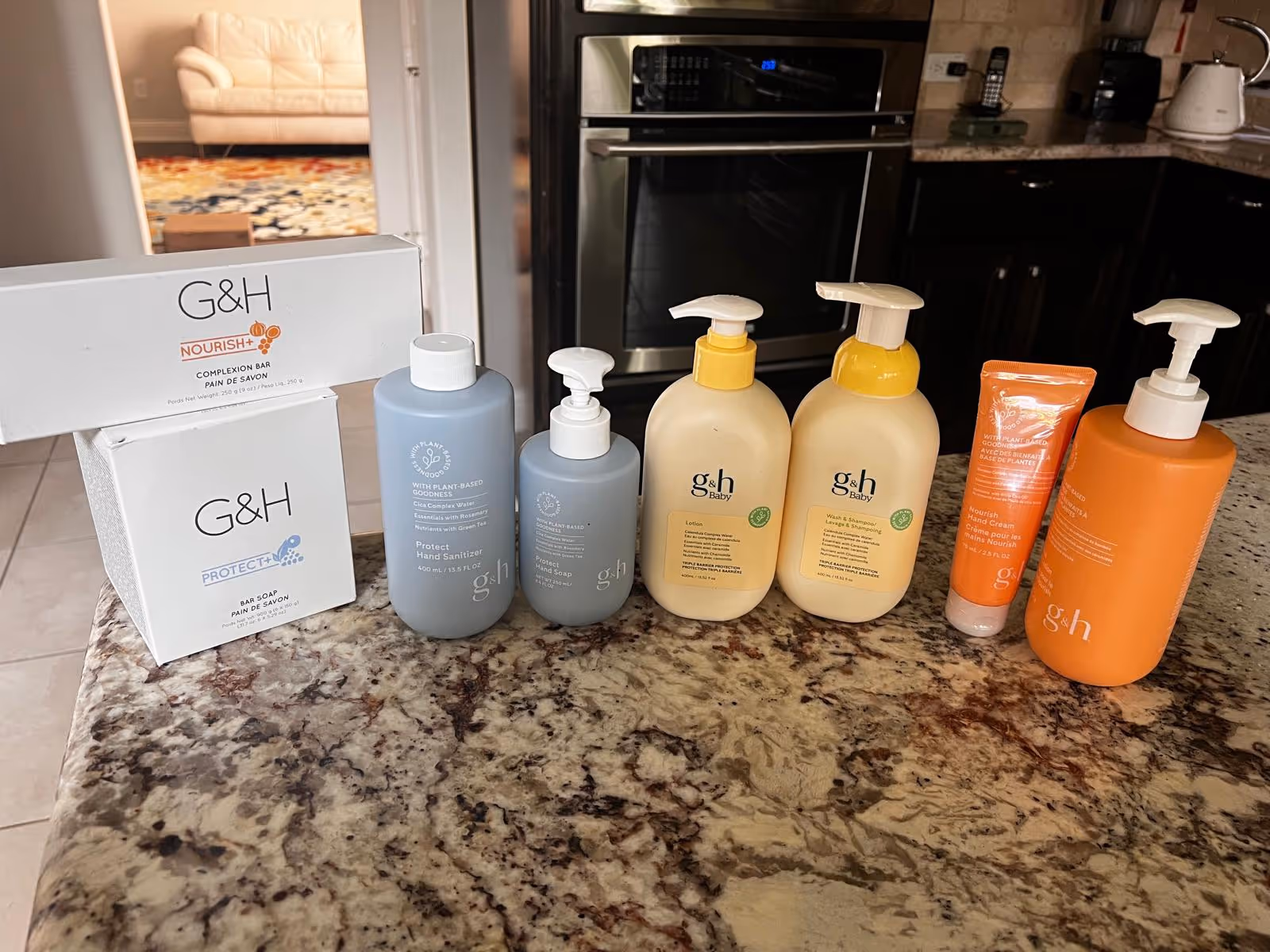 Kitchen countertop with assorted skincare and personal care bottles lined up.