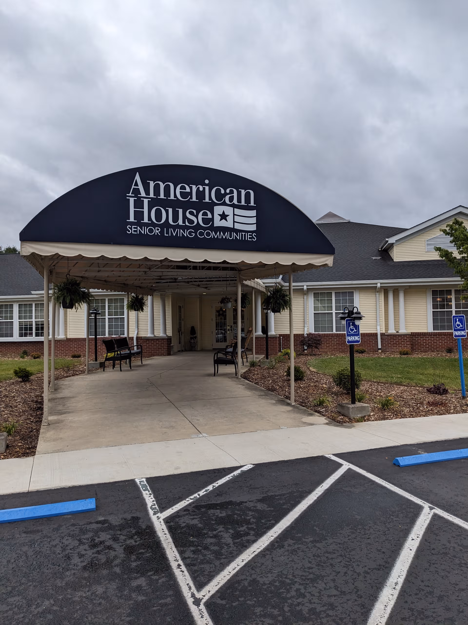 Front entrance canopy and sign mark the American House senior living facility.