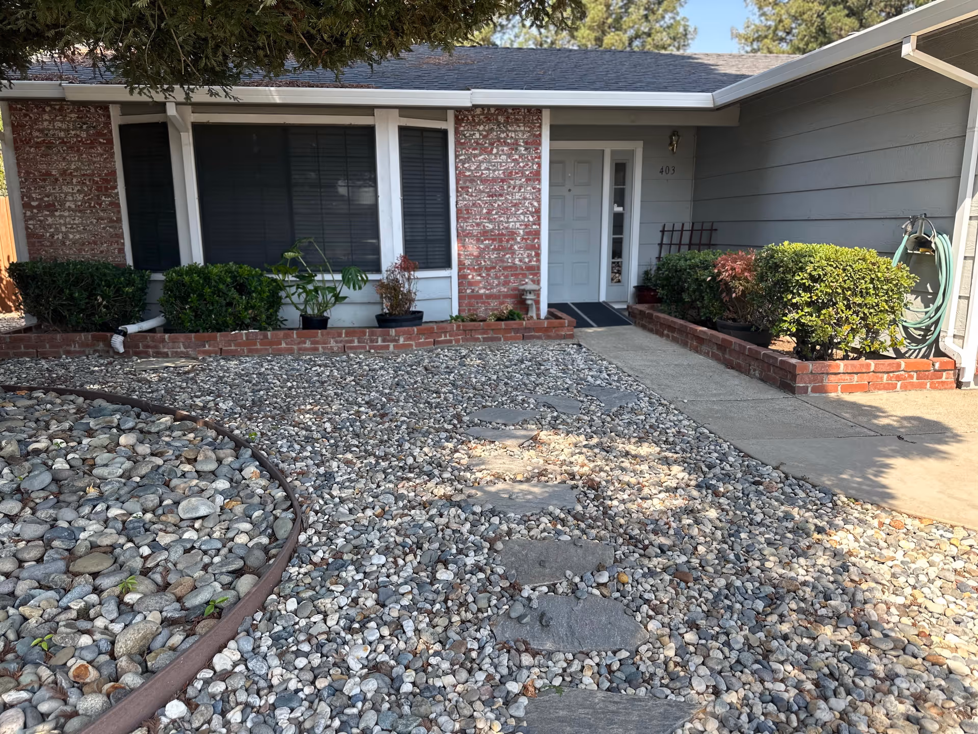 Front exterior of a Diamond Oaks Home Care facility with a gravel yard.