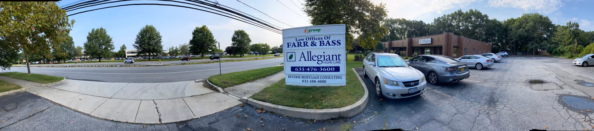 Wide exterior view of Allegiant Home Care facility with parking and sign.
