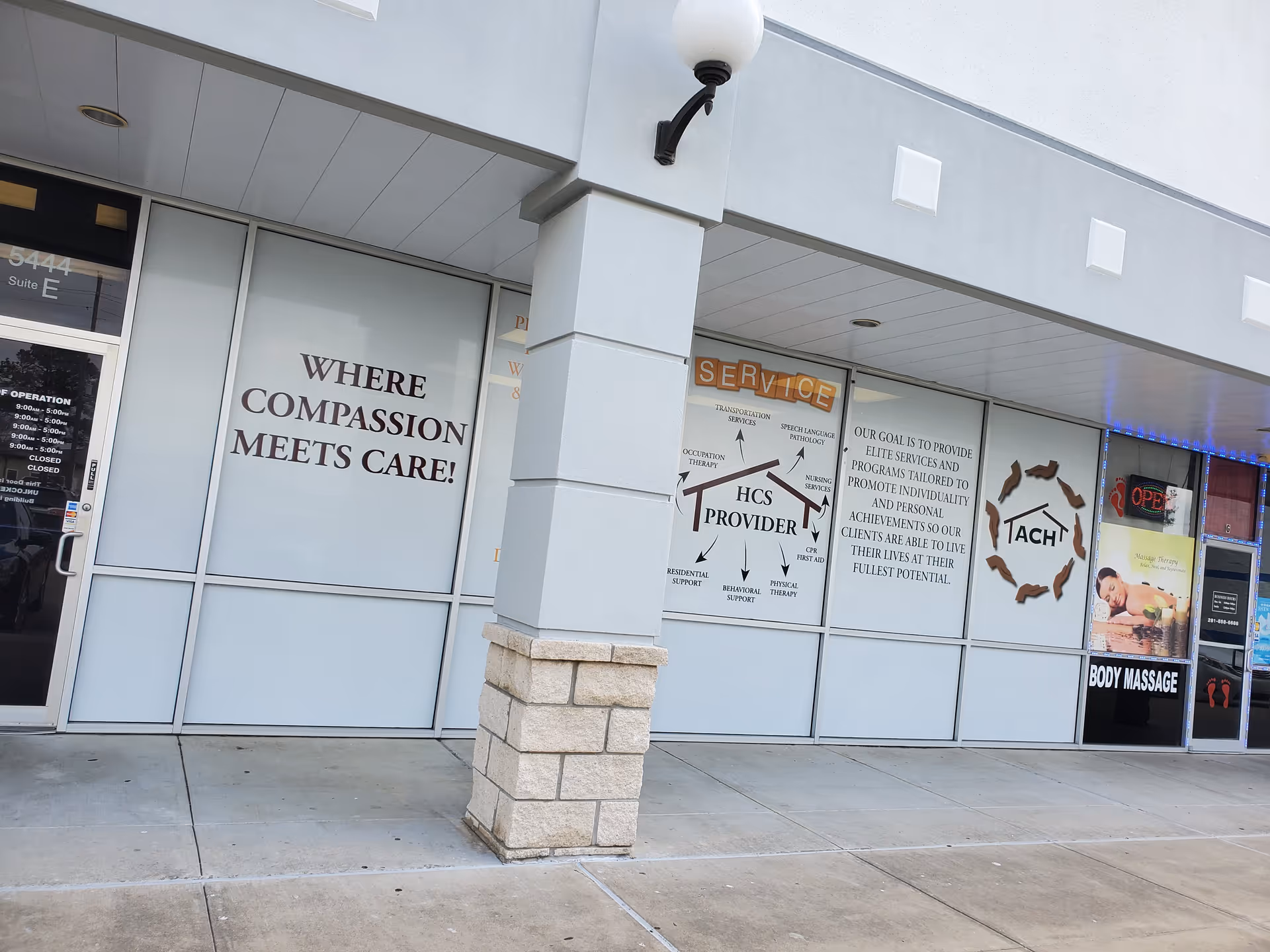 Exterior storefront with large signs on glass windows reading Where compassion meets care.