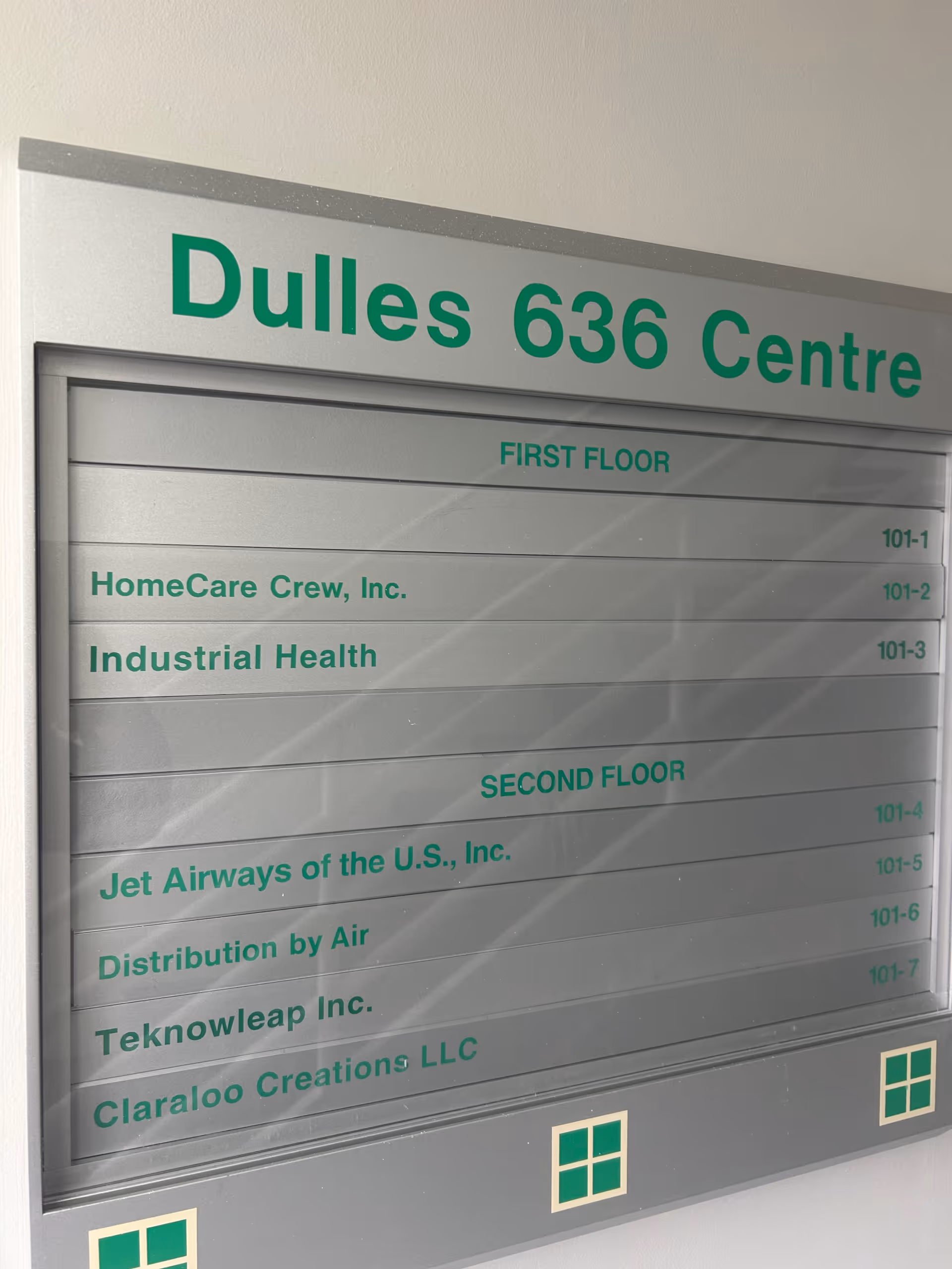 Indoor building directory sign shows Dulles 636 Centre with first and second floor listings.